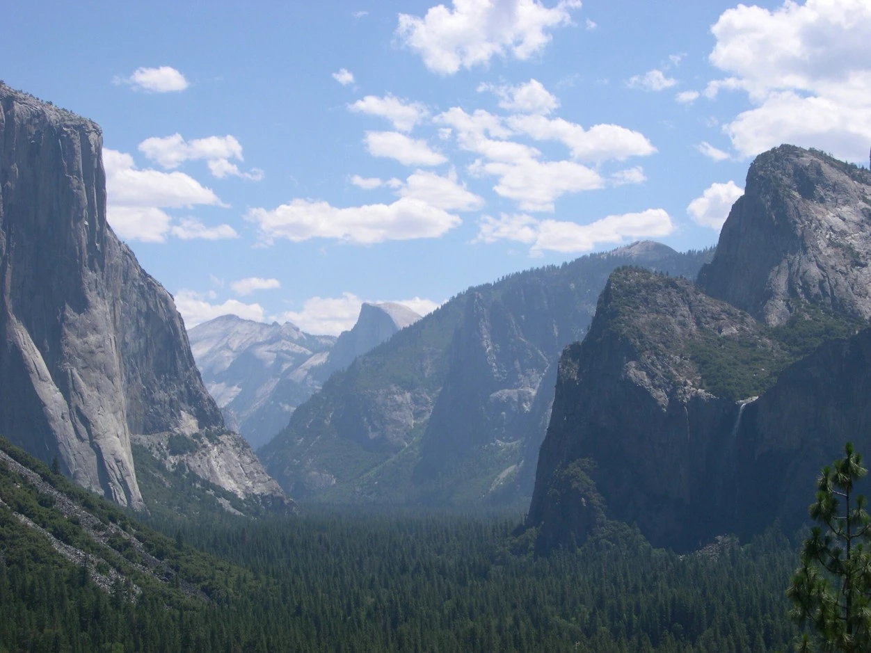 Looking eastward up Yosemite Valley with El Capitan and Bridalveil Falls flanking Half Dome in the distance.